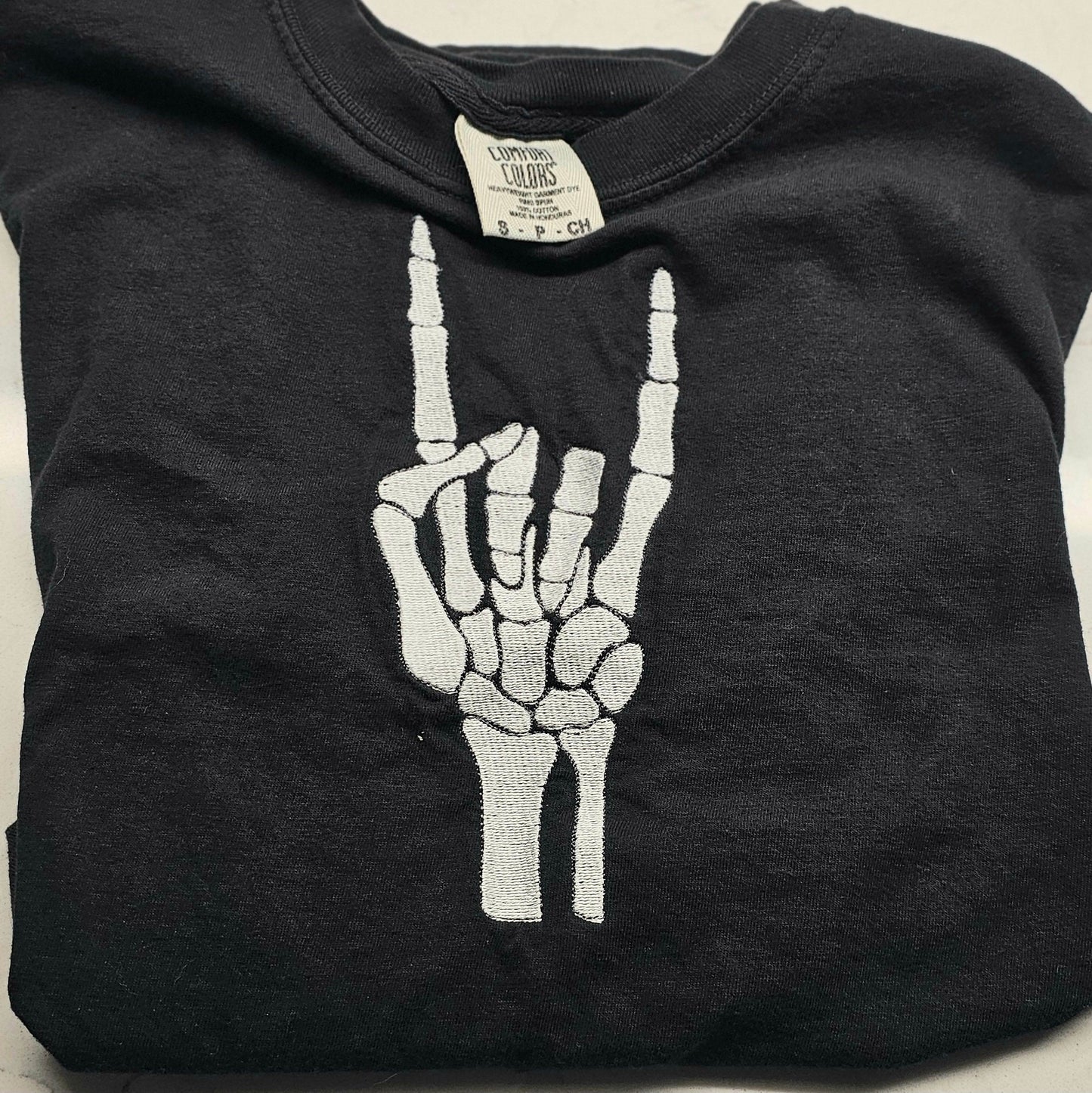 Embroidered Skeleton Rock on Hands Comfort Colors Tee